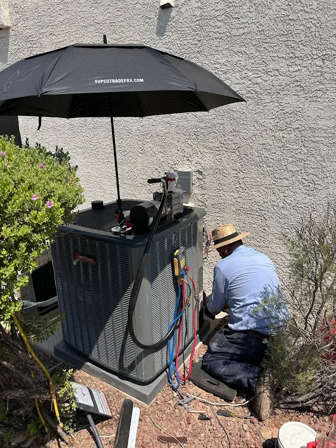 HVAC technician performing outdoor AC maintenance in Leonia